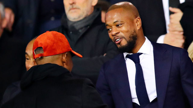 PARIS, FRANCE - MARCH 06: Patrice Evra hugs Samuel Eto'o in the stands before the UEFA Champions League Round of 16 Second Leg match between Paris Saint-Germain and Manchester United at Parc des Princes on March 06, 2019 in Paris, France.