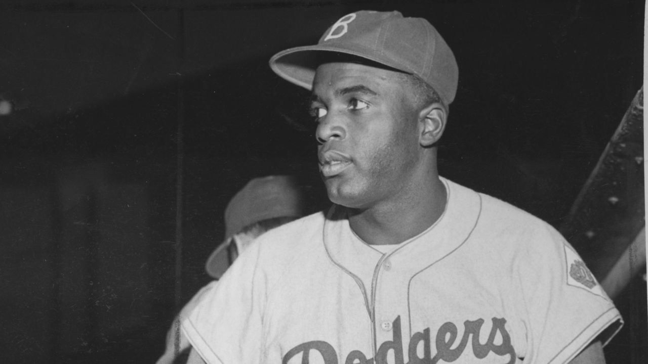 American baseball player Jackie Robinson (1919 - 1972) of the Brooklyn Dodgers prepares for a game, 1948.