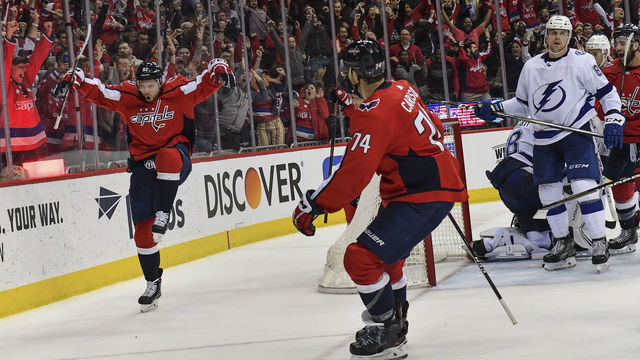WASHINGTON, DC - MARCH 20: Washington Capitals center Evgeny Kuznetsov (92) left, celebrates his game-tying goal in the final minute of play during the third period in a game between the Tampa Bay Lightning and Washington Capitals at Capital One Arena on March 20, 2019 in Washington, D.C. Tampa Bay beat Washington 5-4.