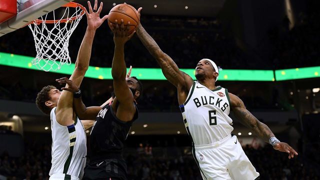 MILWAUKEE, WISCONSIN - MARCH 26: Eric Bledsoe #6 of the Milwaukee Bucks blocks a shot by James Harden #13 of the Houston Rockets during the second half of a game at Fiserv Forum on March 26, 2019 in Milwaukee, Wisconsin.