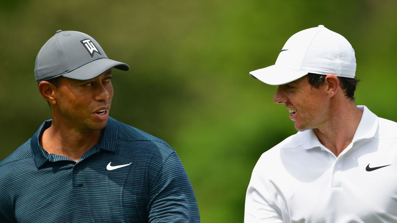 ST LOUIS, MO - AUGUST 09: Tiger Woods of the United States walks with Rory McIlroy of Northern Ireland during the first round of the 2018 PGA Championship at Bellerive Country Club on August 9, 2018 in St Louis, Missouri.