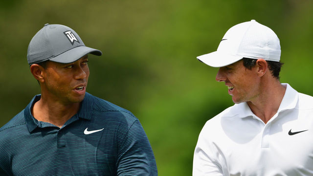 ST LOUIS, MO - AUGUST 09: Tiger Woods of the United States walks with Rory McIlroy of Northern Ireland during the first round of the 2018 PGA Championship at Bellerive Country Club on August 9, 2018 in St Louis, Missouri.