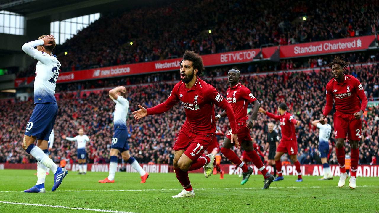 LIVERPOOL, ENGLAND - MARCH 31: Mohamed Salah of Liverpool celebrates after Jan Vertonghen of Tottenham Hotspur scores an own goal to make it 2-1during the Premier League match between Liverpool FC and Tottenham Hotspur at Anfield on March 31, 2019 in Liverpool, United Kingdom.