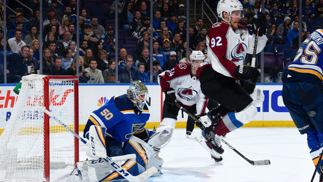ST. LOUIS, MO - APRIL 1: Gabriel Landeskog #92 of the Colorado Avalanche attempts to screen Jordan Binnington #50 of the St. Louis Blues at Enterprise Center on April 1, 2019 in St. Louis, Missouri.