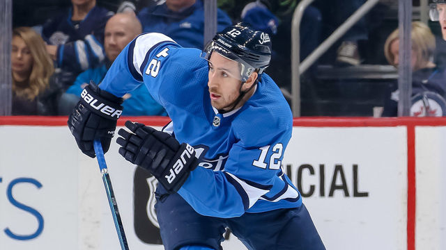 WINNIPEG, MB - MARCH 25: Kevin Hayes #12 of the Winnipeg Jets follows the play down the ice during first period action against the Dallas Stars at the Bell MTS Place on March 25, 2019 in Winnipeg, Manitoba, Canada. The Stars defeated the Jets 5-2.