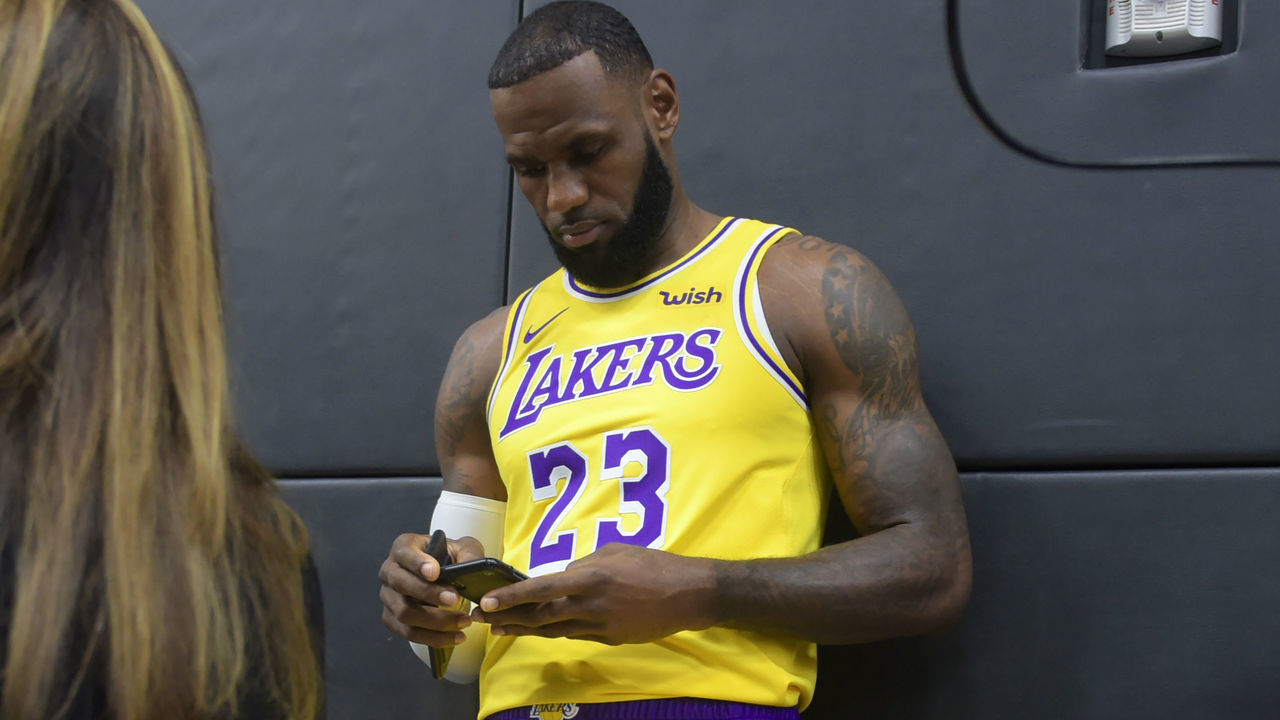 LeBron James checks his cellphone on arrival for his press conference on the Los Angeles Lakers in Los Angeles, California, September 24, 2018, with the Lakers' newest blockbuster signing and teammates met with the media. - The Lakers open their 2018 NBA season in Portland on October 18th.