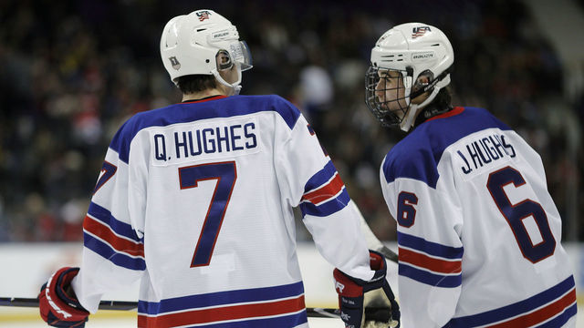 VICTORIA , BC - JANUARY 2: Quinn Hughes #7 and brother Jack Hughes #6 of the United States talk during a quarter-final game versus the Czech Republic at the IIHF World Junior Championships at the Save-on-Foods Memorial Centre on January 2, 2019 in Victoria, British Columbia, Canada.