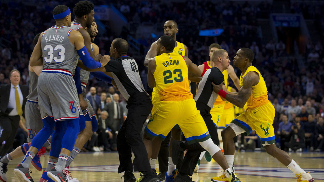 PHILADELPHIA, PA - APRIL 04: Mike Scott #1 of the Philadelphia 76ers and Eric Bledsoe #6 of the Milwaukee Bucks are held back by their teammates after getting into an altercation in the first quarter at the Wells Fargo Center on April 4, 2019 in Philadelphia, Pennsylvania.