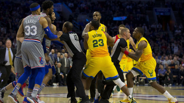 PHILADELPHIA, PA - APRIL 04: Mike Scott #1 of the Philadelphia 76ers and Eric Bledsoe #6 of the Milwaukee Bucks are held back by their teammates after getting into an altercation in the first quarter at the Wells Fargo Center on April 4, 2019 in Philadelphia, Pennsylvania.