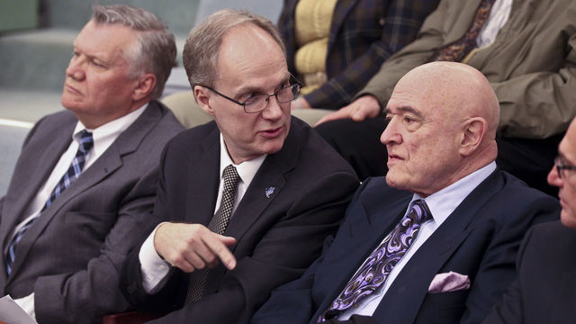 Graeme Roustan, (L) chairman of Bauer Performance Sports Ltd., and real estate mogul Rudy Bratty sit in the audience as Markham town council talks about voting to borrow millions for NHL-sized arena. April 26, 2012