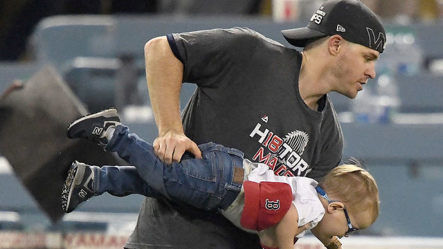 LOS ANGELES, CA - OCTOBER 28: Brock Holt #12 of the Boston Red Sox celebrates with his son after his team's 5-1 win over the Los Angeles Dodgers in Game Five of the 2018 World Series at Dodger Stadium on October 28, 2018 in Los Angeles, California.