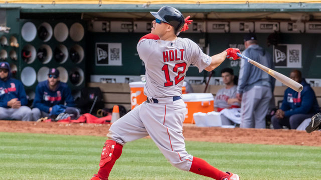 OAKLAND, CA - APRIL 04: Boston Red Sox second baseman Brock Holt (12) sends a high fly ball to the outfield during the game between the Boston Red Sox and the Oakland Athletics on Thursday, April 04, 2019 at O.co Coliseum in Oakland, California.