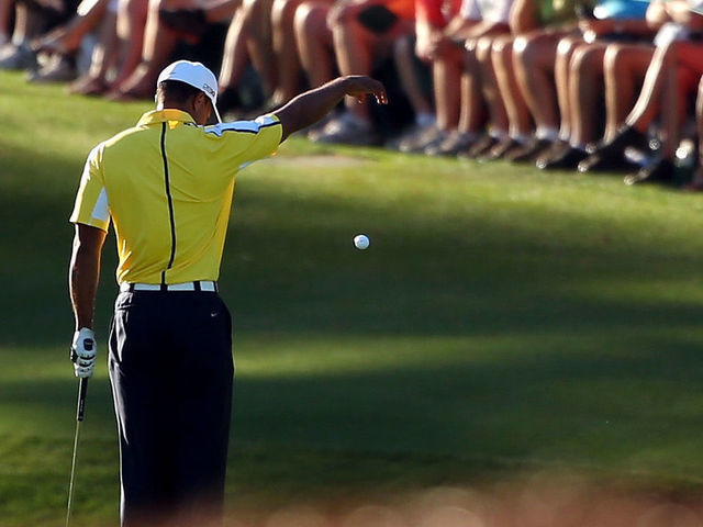 AUGUSTA, GA - APRIL 12: Tiger Woods of the United States drops his ball after he hits it into the water on the 15th hole during the second round of the 2013 Masters Tournament at Augusta National Golf Club on April 12, 2013 in Augusta, Georgia.