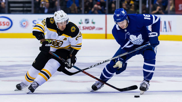 TORONTO, ON - NOVEMBER 26: Mitchell Marner #16 of the Toronto Maple Leafs and Brad Marchand #63 of the Boston Bruins battle for the puck during the first period at the Scotiabank Arena on November 26, 2018 in Toronto, Ontario, Canada.
