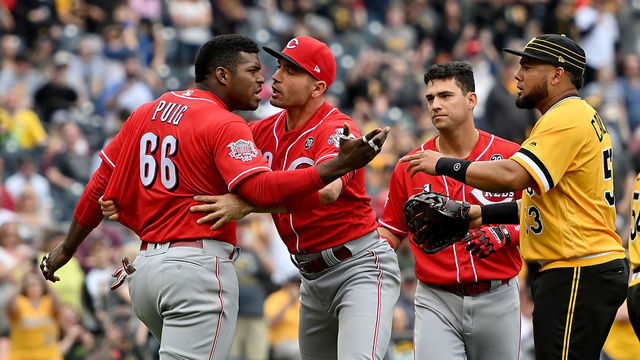 PITTSBURGH, PA - APRIL 07: Yasiel Puig #66 of the Cincinnati Reds is restrained by Joey Votto #19 after benches clear in the fourth inning during the game against the Pittsburgh Pirates at PNC Park on April 7, 2019 in Pittsburgh, Pennsylvania.