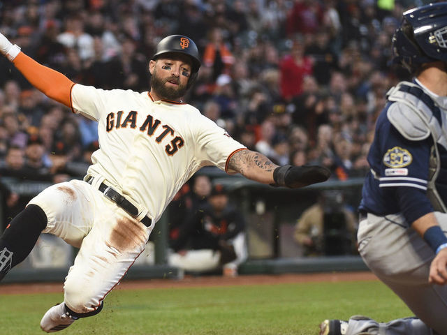 San Francisco Giants starting pitcher Madison Bumgarner touches his beard  as he walks back to the mound while working against the San Diego Padres  during the third inning of a baseball game