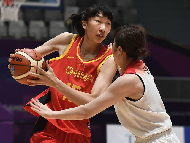 JAKARTA, INDONESIA - AUGUST 30: Han Xu#15 of China battles Umezawa Kadysha Juna of Japan during the Women's Basketball Semi Final match between Japan and China at the GBK Istora Hall on day twelve of the 18th Asian Games on August 30, 2018 in Jakarta, Indonesia.
