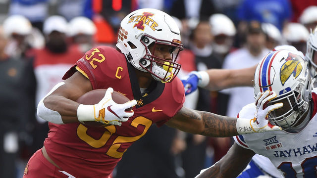 LAWRENCE, KS - NOVERMBER 3: Running back David Montgomery #32 of the Iowa State Cyclones stiff arms cornerback Julian Chandler #10 of the Kansas Jayhawks as he rushes in the first quarter at Memorial Stadium on November 3, 2018 in Lawrence, Kansas.