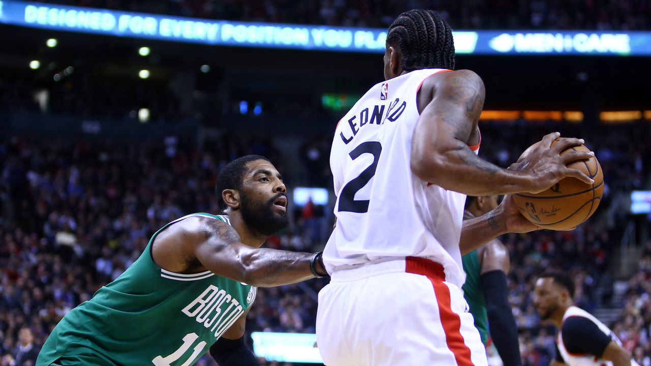 TORONTO, ON - FEBRUARY 26: Kawhi Leonard #2 of the Toronto Raptors dribbles the ball as Kyrie Irving #11 of the Boston Celtics defends during the second half of an NBA game at Scotiabank Arena on February 26, 2019 in Toronto, Canada.