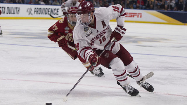 BUFFALO, NY - APRIL 11: Massachusetts Minutemen Defenseman Cale Makar (16) skates with the puck with Denver Pioneers Defenseman Kyle Mayhew (27) in pursuit during the second period of the game between the Massachusetts Minutemen and the Denver Pioneers on April 11, 2019, at the Key Bank Center in Buffalo, NY.