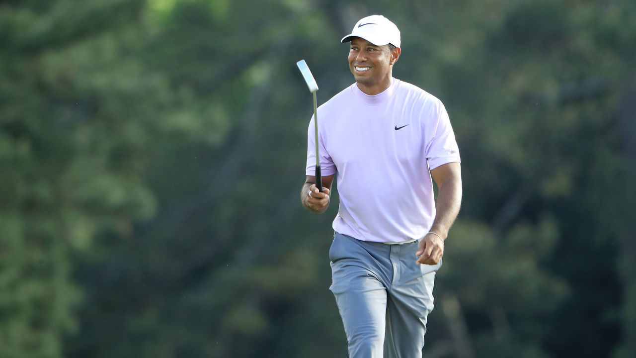AUGUSTA, GEORGIA - APRIL 13: Tiger Woods of the United States smiles as he walks on the 18th hole during the third round of the Masters at Augusta National Golf Club on April 13, 2019 in Augusta, Georgia.