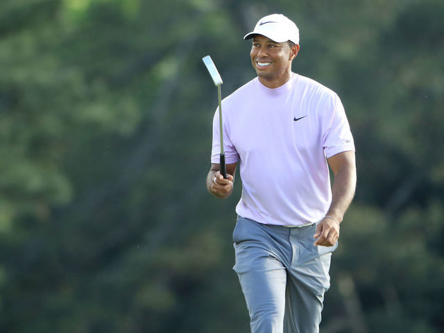 AUGUSTA, GEORGIA - APRIL 13: Tiger Woods of the United States smiles as he walks on the 18th hole during the third round of the Masters at Augusta National Golf Club on April 13, 2019 in Augusta, Georgia.