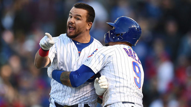 CHICAGO, ILLINOIS - APRIL 13: Kyle Schwarber #12 of the Chicago Cubs is restrained by Javier Baez #9 after being called out by the third base umpire during the ninth inning of a game against the Los Angeles Angels at Wrigley Field on April 13, 2019 in Chicago, Illinois.