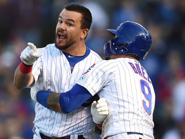 CHICAGO, ILLINOIS - APRIL 13: Kyle Schwarber #12 of the Chicago Cubs is restrained by Javier Baez #9 after being called out by the third base umpire during the ninth inning of a game against the Los Angeles Angels at Wrigley Field on April 13, 2019 in Chicago, Illinois.