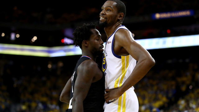 OAKLAND, CALIFORNIA - APRIL 13: Patrick Beverley #21 of the LA Clippers plays tight defense on Kevin Durant #35 of the Golden State Warriors during Game One of the first round of the 2019 NBA Western Conference Playoffs at ORACLE Arena on April 13, 2019 in Oakland, California. Both players were ejected later in the game.