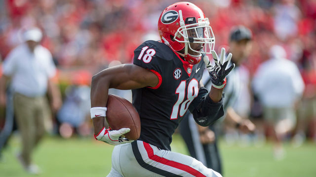 ATHENS, GA - APRIL 21:Georgia Bulldogs defensive back Deandre Baker (18) takes a Georgia Bulldogs quarterback Jake Fromm (11) interception to the end zone to put the black team up 7-0 during the annual G-Day Spring football game at Sanford Stadium in Athens, Ga on April 21, 2018.