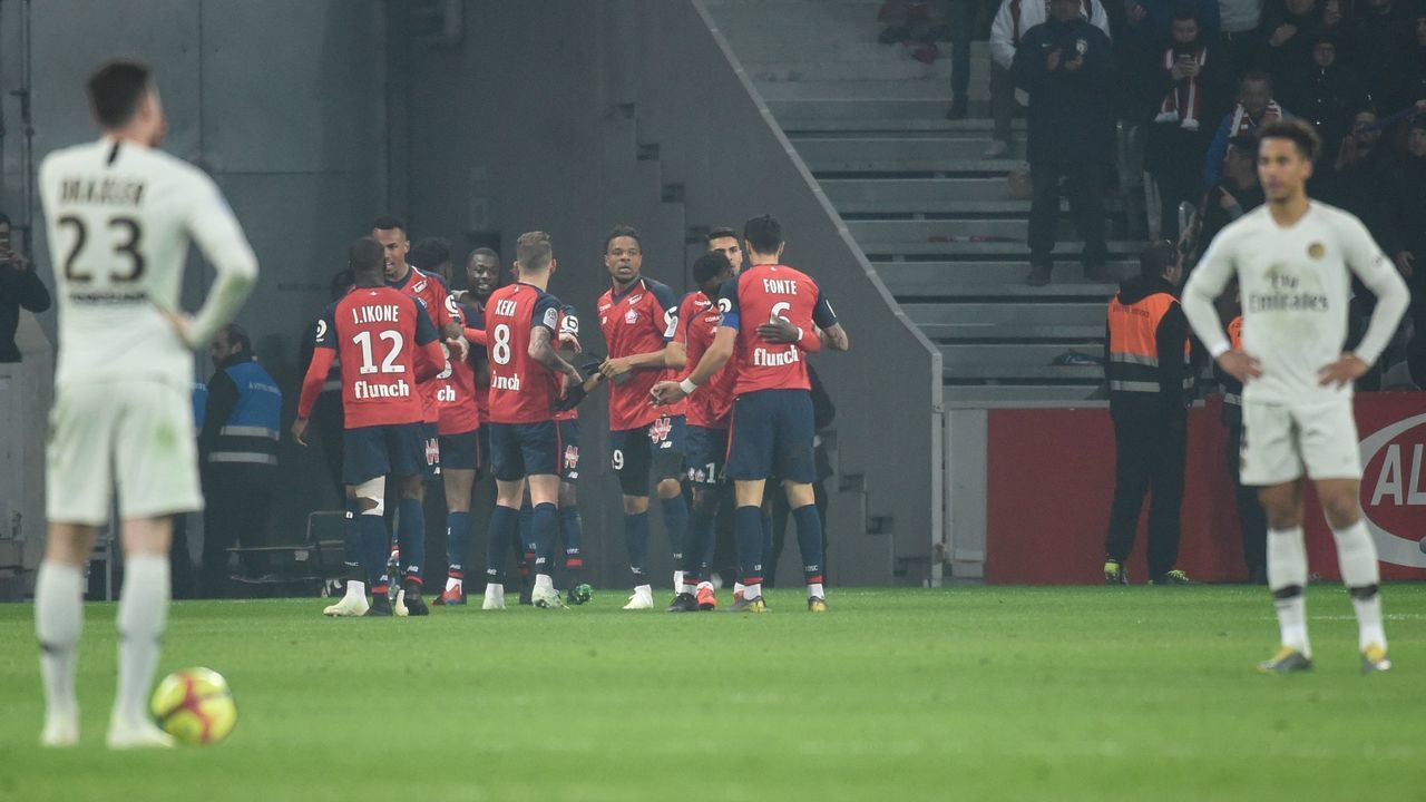 Lille's Ivorian forward Nicolas Pepe (C) is congratulated by teammates after scoring a goal during the French L1 football match between Lille (LOSC) and Paris Saint-Germain (PSG) on April 14, 2019, at the Pierre-Mauroy Stadium in Villeneuve d'Ascq, near Lille, northern France.
