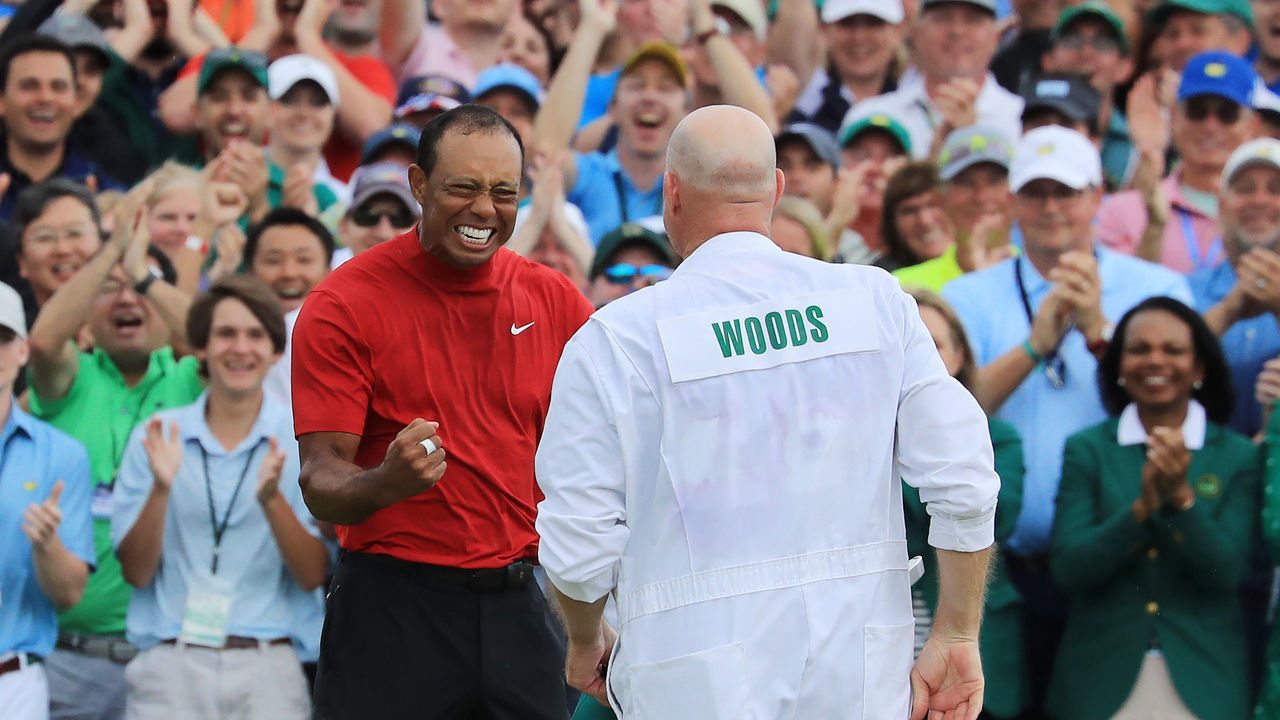 AUGUSTA, GEORGIA - APRIL 14: Tiger Woods (L) of the United States celebrates with caddie Joe LaCava (R) on the 18th green after winning during the final round of the Masters at Augusta National Golf Club on April 14, 2019 in Augusta, Georgia.