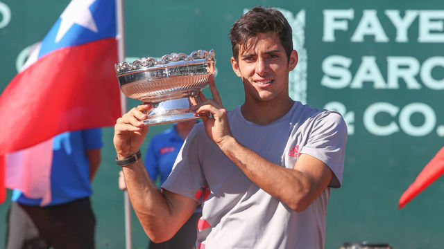 HOUSTON, TX - APRIL 14: Christian Garin (CHI) poses with the trophy after winning the U.S. Men's Clay Court Championship singles final on April 14, 2019 at River Oaks Country Club in Houston, TX.