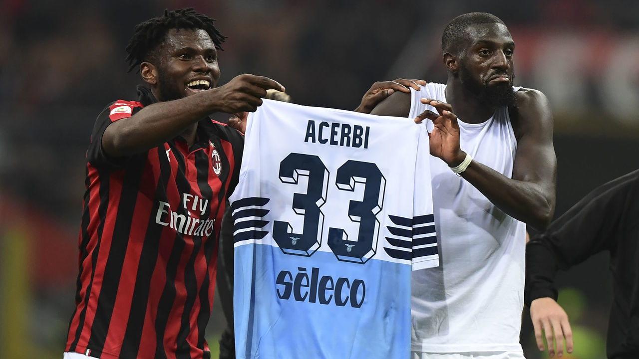 AC Milan's Ivorian midfielder Franck Kessie and AC Milan's French midfielder Tiemoue Bakayoko hold the jersey of Lazio's Italian defender Francesco Acerbi at the end of the Italian Serie A football match AC Milan vs Lazio Rome on April 13, 2019 at the San Siro stadium in Milan.