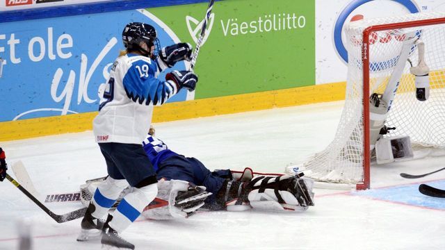 Goalkeeper Alex Rigsby of the United States lies on the ice while Petra Nieminen of Finland (L) starts celebrating her game-winning overtime goal which was later disallowed during the IIHF Women's Ice Hockey World Championships final match between the United States and Finland in Espoo, Finland, on April 14, 2019.