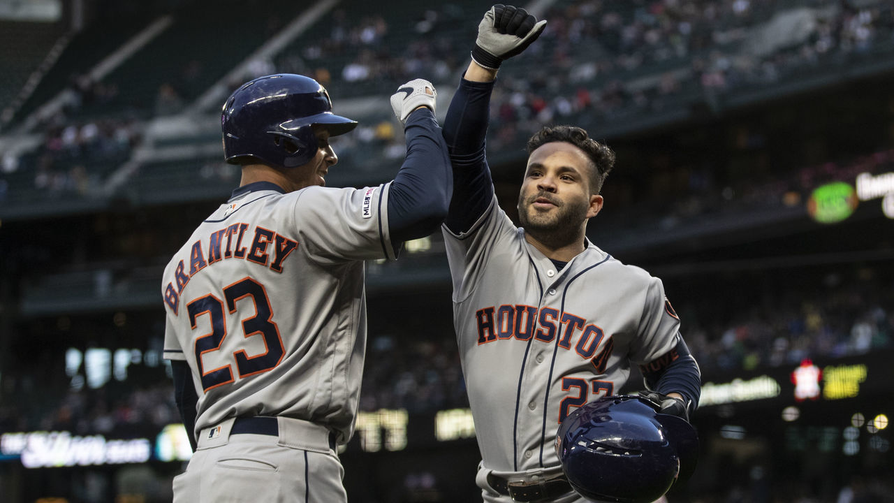 SEATTLE, WA - APRIL 13: Jose Altuve #27 of the Houston Astros is congratulated by Michael Brantley #23 of the Houston Astros after hitting a solo home run off of starting pitcher Felix Hernandez #34 of the Seattle Mariners during the fifth inning of a game at T-Mobile Park on April 13, 2019 in Seattle, Washington.