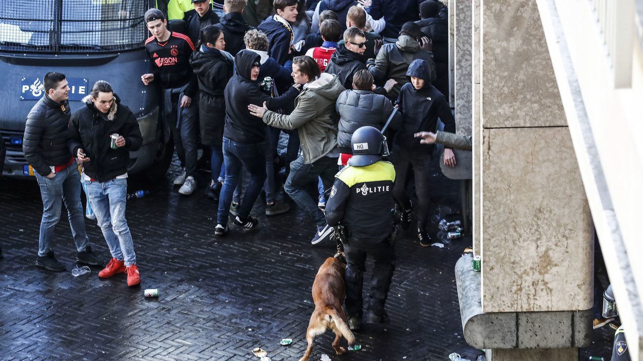 Dutch police officers surround Ajax's supporters ahead of the UEFA Champions League first leg quarter-final football match between Ajax Amsterdam and Juventus FC at the Johan Cruijff ArenA in Amsterdam on April 10, 2019.