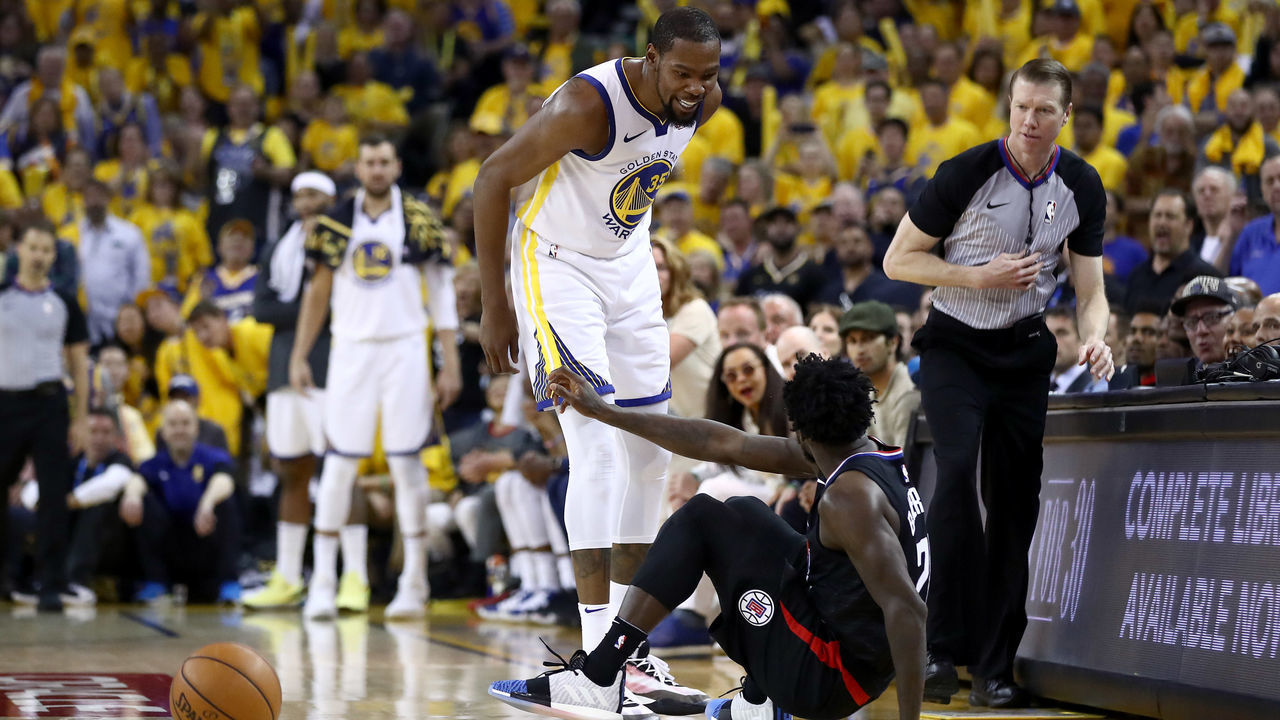 OAKLAND, CALIFORNIA - APRIL 13: Kevin Durant #35 of the Golden State Warriors has words with Patrick Beverley #21 of the LA Clippers during Game One of the first round of the 2019 NBA Western Conference Playoffs at ORACLE Arena on April 13, 2019 in Oakland, California. Both players were ejected after the play.