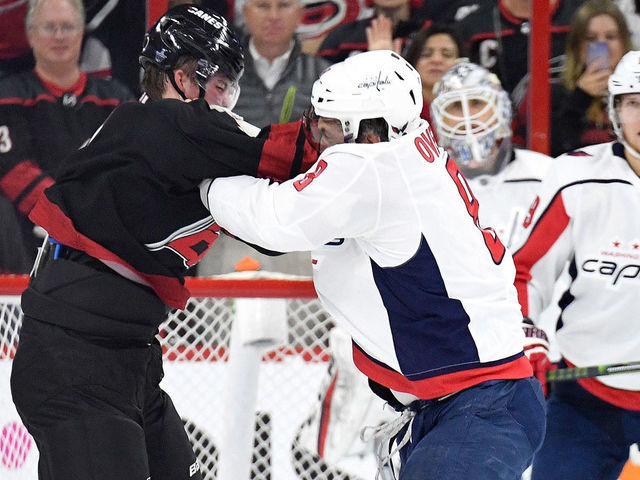 RALEIGH, NORTH CAROLINA - APRIL 15: Alex Ovechkin #8 of the Washington Capitals knocks out Andrei Svechnikov #37 of the Carolina Hurricanes as they fight during the first period in Game Three of the Eastern Conference First Round during the 2019 NHL Stanley Cup Playoffs at PNC Arena on April 15, 2019 in Raleigh, North Carolina.