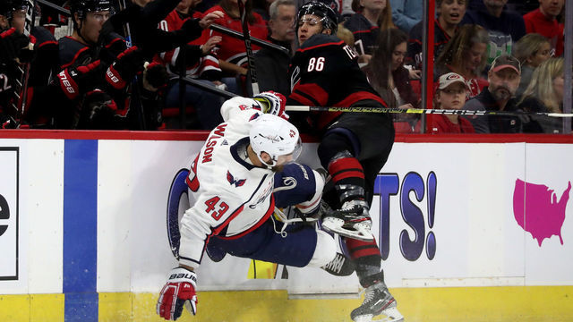 RALEIGH, NC - APRIL 15: Tom Wilson #43 of the Washington Capitals goes airborne after colliding with Teuvo Teravainen #86 of the Carolina Hurricanes in Game Three of the Eastern Conference First Round during the 2019 NHL Stanley Cup Playoffs on April 15, 2019 at PNC Arena in Raleigh, North Carolina.