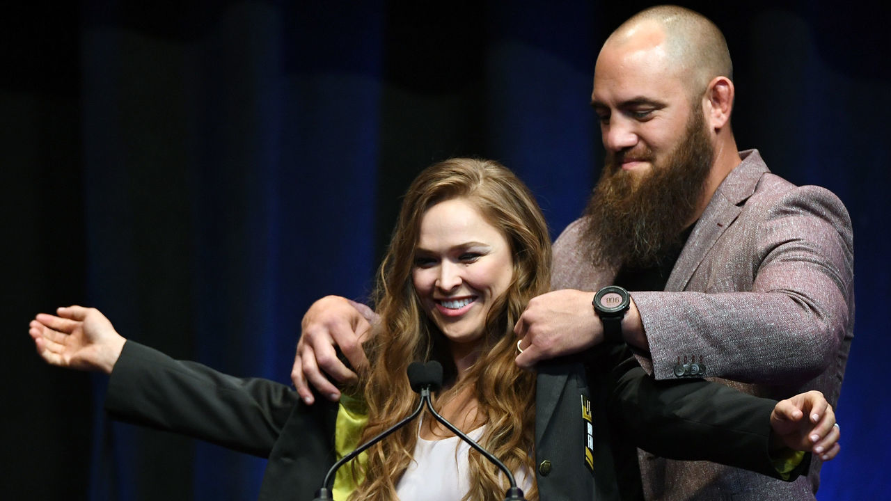 LAS VEGAS, NV - JULY 05: Mixed martial artist Travis Browne (R) puts a UFC Hall of Fame jacket on his wife Ronda Rousey after she became the first female inducted into the UFC Hall of Fame at The Pearl concert theater at Palms Casino Resort on July 5, 2018 in Las Vegas, Nevada.