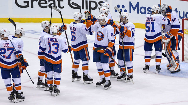 PITTSBURGH, PA - APRIL 14: New York Islanders goaltender Robin Lehner (40) is mobbed by teammates after a win in Game 3 of the First Round in the 2019 NHL Stanley Cup Playoffs between the New York Islanders and the Pittsburgh Penguins on April 14, 2019, at PPG Paints Arena in Pittsburgh, PA.