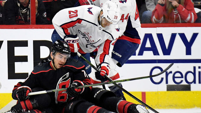 RALEIGH, NORTH CAROLINA - APRIL 15: Micheal Ferland #79 of the Carolina Hurricanes battles Lars Eller #20 and Brooks Orpik #44 of the Washington Capitals for the puck during the first period in Game Three of the Eastern Conference First Round during the 2019 NHL Stanley Cup Playoffs at PNC Arena on April 15, 2019 in Raleigh, North Carolina.