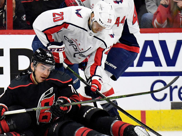 RALEIGH, NORTH CAROLINA - APRIL 15: Micheal Ferland #79 of the Carolina Hurricanes battles Lars Eller #20 and Brooks Orpik #44 of the Washington Capitals for the puck during the first period in Game Three of the Eastern Conference First Round during the 2019 NHL Stanley Cup Playoffs at PNC Arena on April 15, 2019 in Raleigh, North Carolina.