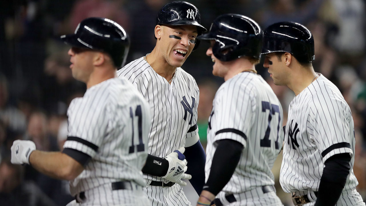 NEW YORK, NEW YORK - APRIL 17: Aaron Judge #99 of the New York Yankees congratulates teammates Brett Gardner #11,Clint Frazier #77 and Mike Tauchman #39 after Gardner hit a grand slam in the seventh inning against the Boston Red Sox at Yankee Stadium on April 17, 2019 in New York City.Aaron Judge was on deck on the play.