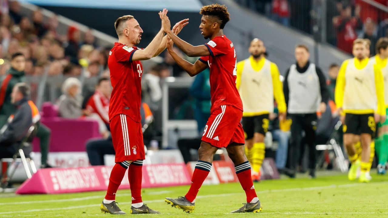 MUNICH, GERMANY - APRIL 06: Franck Ribery of FC Bayern Muenchen substitutes Kingsley Coman of FC Bayern Muenchen during the Bundesliga match between FC Bayern Muenchen and Borussia Dortmund at Allianz Arena on April 06, 2019 in Munich, Germany.