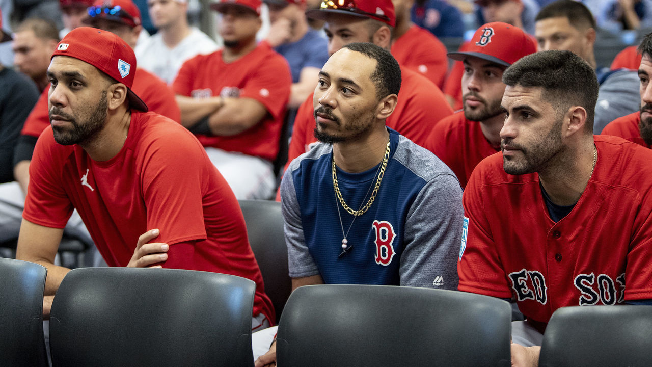 FT. MYERS, FL - FEBRUARY 18: David Price #10, Mookie Betts #50, and J.D. Martinez #28 of the Boston Red Sox look on during a team meeting before a team workout on February 18, 2019 at JetBlue Park at Fenway South in Fort Myers, Florida.