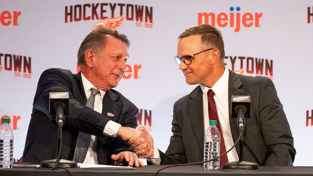 DETROIT, MI - APRIL 19: Kenny Holland, promoted to Senior Vice President, shakes hands with Steve Yzerman, the new Executive Vice President and General Manager of the Detroit Red Wings during a press conference at Little Caesars Arena on April 19, 2019 in Detroit, Michigan.
