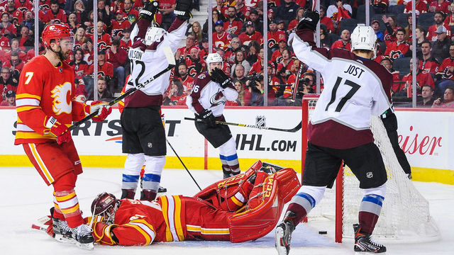 CALGARY, AB - APRIL 19: Colin Wilson #22 of the Colorado Avalanche scores on the net of Mike Smith #41 of the Calgary Flames in Game Five of the Western Conference First Round during the 2019 NHL Stanley Cup Playoffs at Scotiabank Saddledome on April 19, 2019 in Calgary, Alberta, Canada.