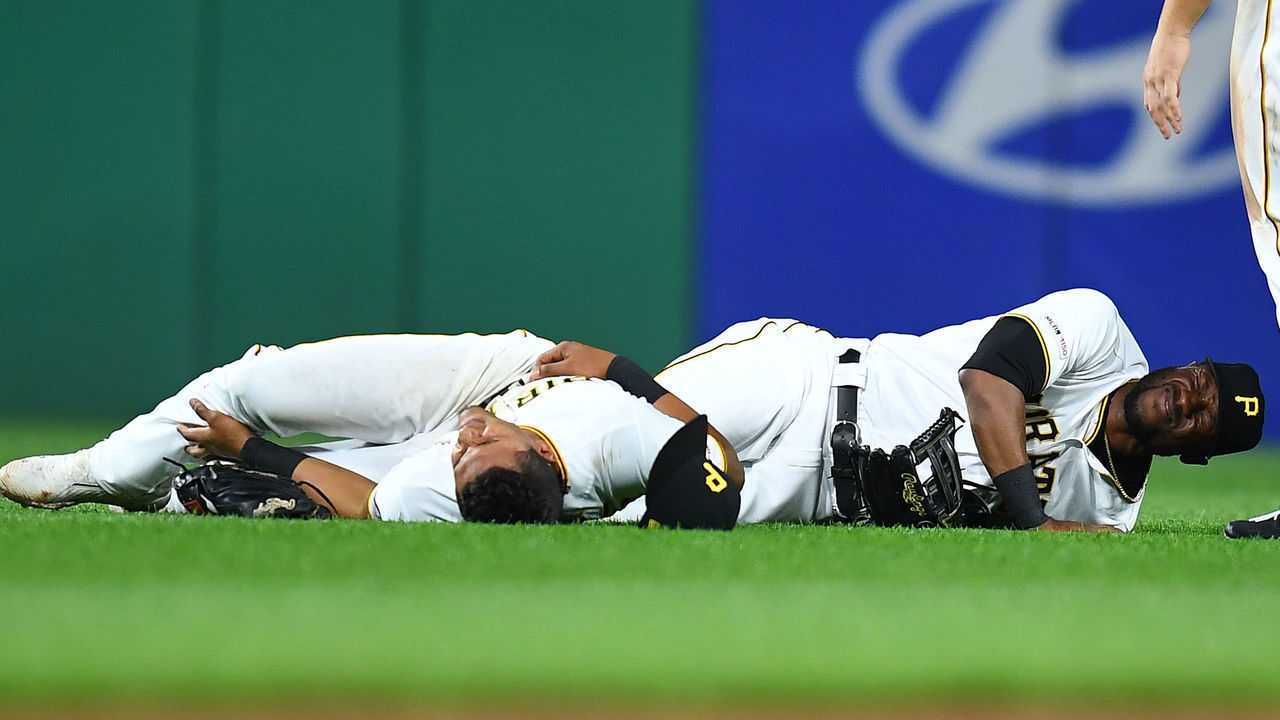 PITTSBURGH, PA - APRIL 19: Erik Gonzalez #2 and Starling Marte #6 of the Pittsburgh Pirates are injured after colliding during the eighth inning against the San Francisco Giants at PNC Park on April 19, 2019 in Pittsburgh, Pennsylvania.